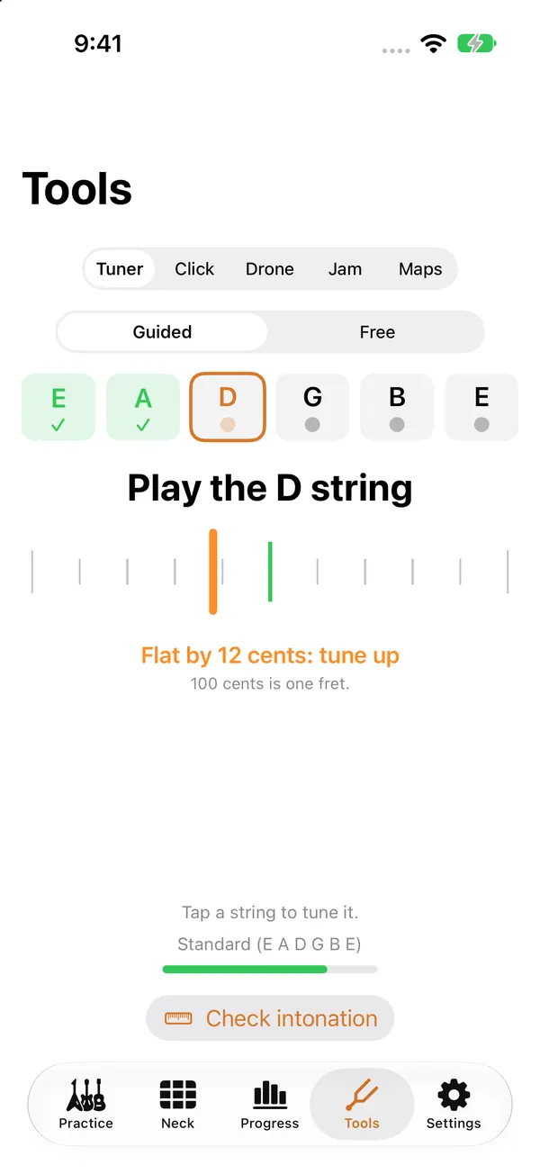 The guided tuner: Play the D string. The needle shows it 12 cents flat, with the words Flat by 12 cents: tune up. The low E and A strings are already ticked.